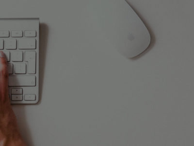 person typing to a keyboard