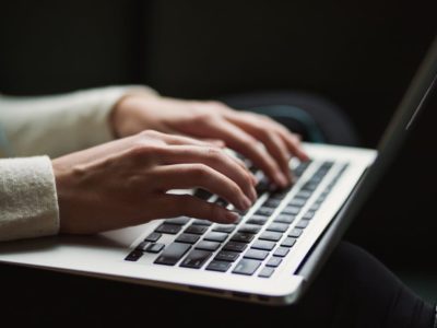 A girl typing on her laptop