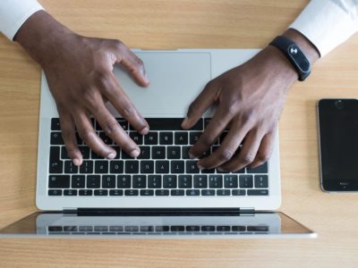 hands typing on laptop keyboard