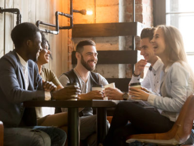 People having coffee laughing together 