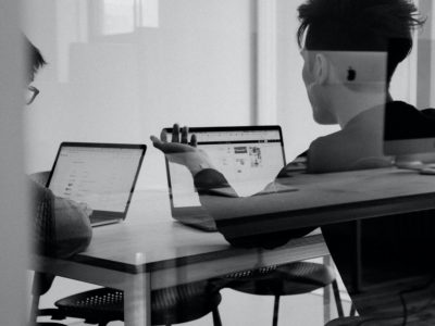 silhouette of a person holding a laptop