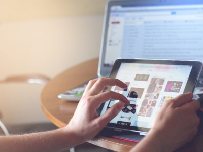 hands pointing at a smart tablet